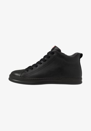 Black high-top sneakers made of smooth leather, featuring a rounded toe, contrast stitching, and a logo accent on the heel.