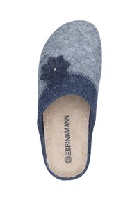 Gray and navy felt slipper with a round toe, flower accent, and stitched detailing. Inner sole has branding printed on a beige background.