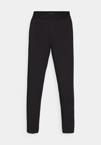 Zwarte sportieve broek met een elastische tailleband, taps toelopend ontwerp, gladde textuur en minimale stikseldetails. Geen zakken.