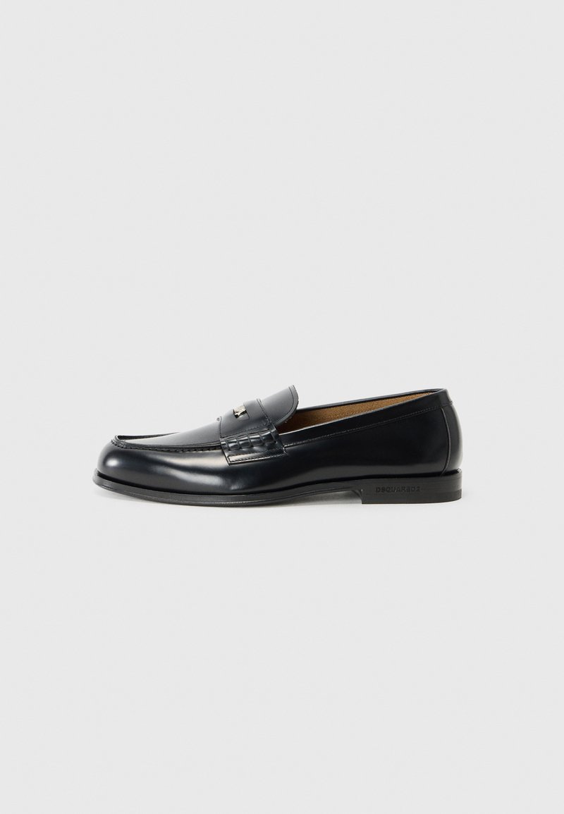 Leather loafers in black with a smooth finish, rounded toe, decorative stitching, and a small metal accent on the front.