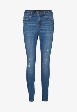 Siniset kapeat farkut, joissa kevyttä kulutusta etureisissä, viiden taskun malli, napitettava sulkeminen ja vyölenkit.