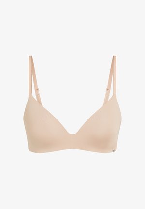 Beiger nahtloser drahtloser BH mit verstellbaren dünnen Trägern und glatten Cups, entworfen für Komfort und den täglichen Gebrauch.