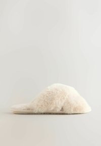Cream-colored faux fur slide slipper with a wide, fluffy band, flat sole, and textured surface for grip. Simple, streamlined shape.