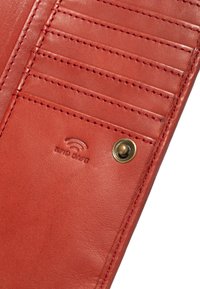 Red leather wallet with multiple card slots, visible stitching, and a brass snap button. Features an embossed "RFID Safe" logo.