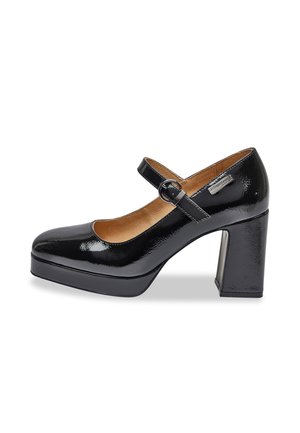 Black patent leather Mary Jane shoe with a rounded toe, chunky heel, and adjustable strap, featuring a smooth texture and subtle shine.