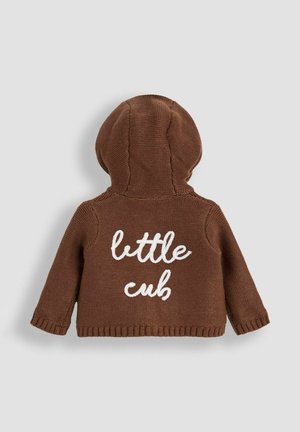 Hanorac maro tricotat cu finisaj texturat, având un text alb „pui mic” pe spate. Are o glugă rotunjită și manșete ribate.