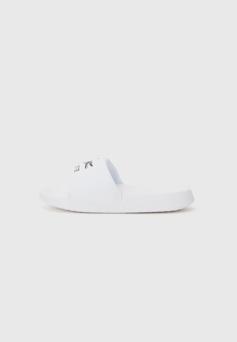 Vit slidesandal gjord av syntetiskt material, med ett brett rem med svart logotyp och en strukturerad sula för bra grepp.