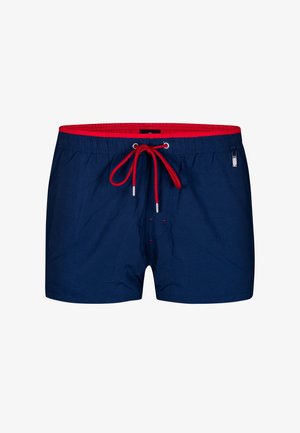 Marineblå svømmedragter med elastisk talje, rød snor og sølvhardware. Har en glat overflade og et enkelt design.