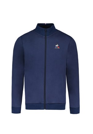 Giacca zip navale realizzata in tessuto liscio, con colletto alto, tasche laterali, polsini a costine e un logo sul lato sinistro del petto.