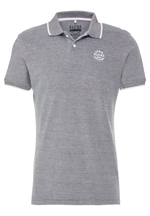 Hallitanhallaneheline polo särk, millel on tekstureeritud kangas, kontrastse äärega krae, kolme nööbiga liigendus ning ringikujuline logo rinnal.