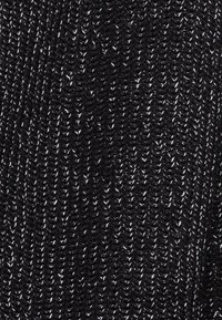 Black knitted fabric with a fine, textured pattern and subtle silver threads woven throughout, creating a distinct contrast and sheen.