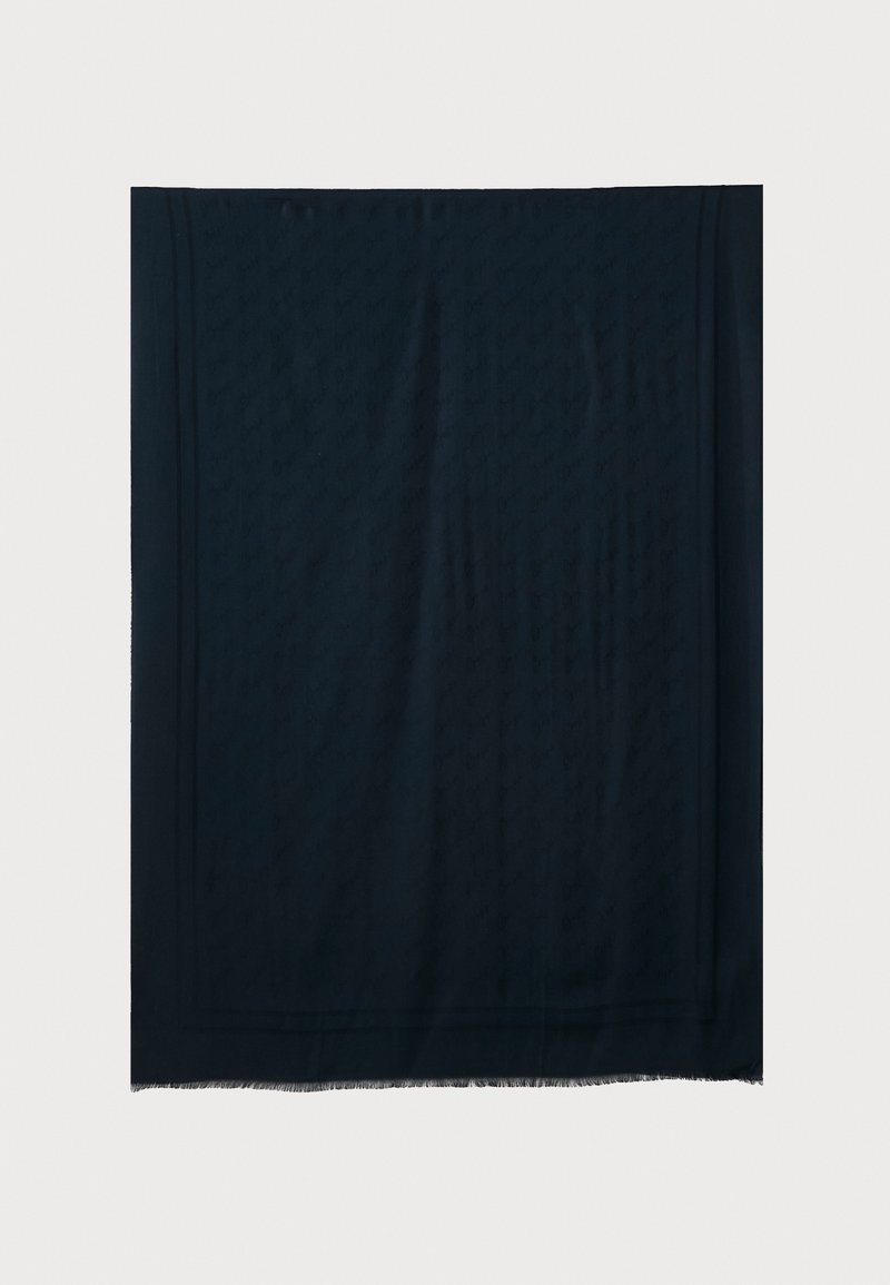 Dark navy scarf made from a soft fabric, featuring a subtle embossed pattern and fringed edges. Square shape with clean lines.
