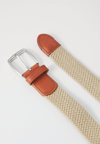 Woven beige fabric belt with brown leather accents and silver metal buckle; features stitched details on leather ends.