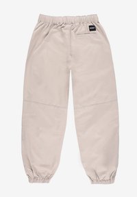 Jasno beżowe spodnie z elastycznym paskiem w luźnym kroju, zebranymi mankietami i małą czarną metką z tyłu. Gładki, lekki materiał.