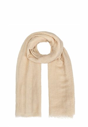 Beżowy szal o teksturowanym, tkanym wykończeniu, wykonany z miękkiego, lekkiego materiału, z frędzlami na krawędziach, zwinięty w luźną pętlę.