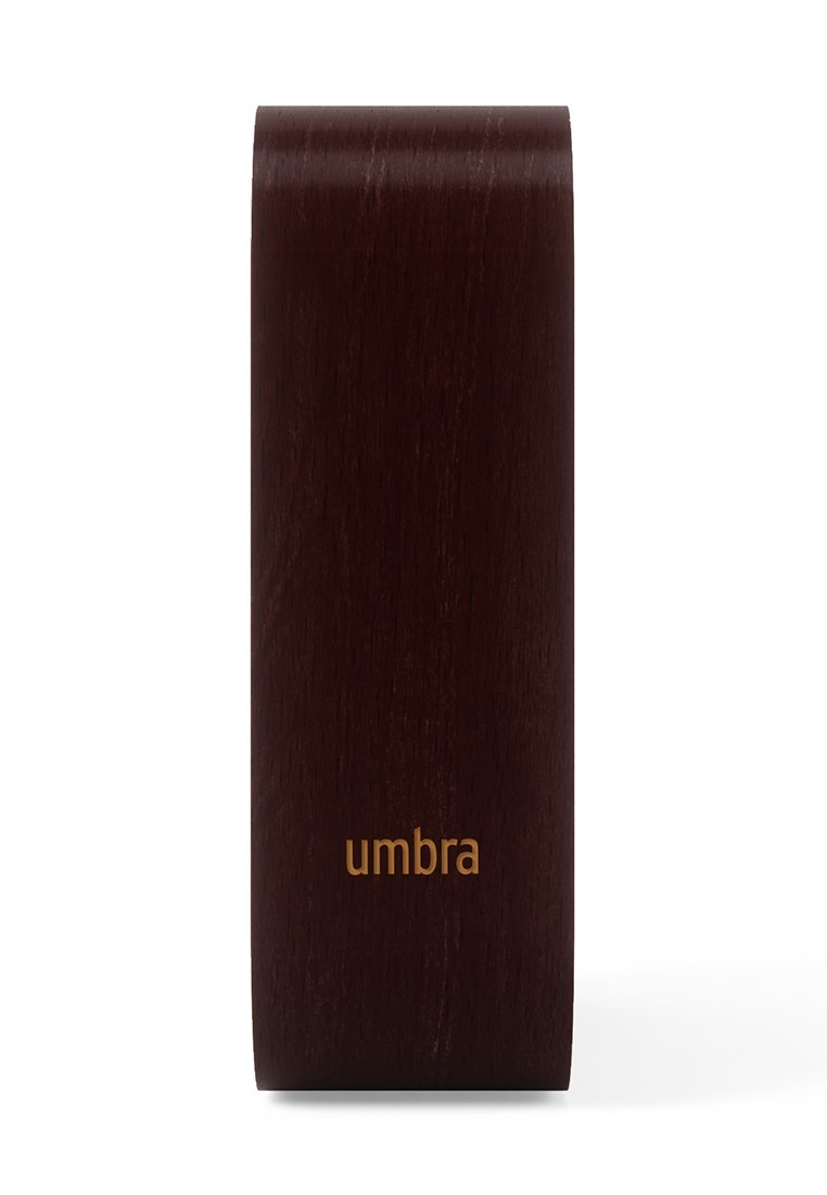 Blok drewniany Umbra w ciemnym brązie o gładkiej fakturze. Posiada subtelne logo w złotym kolorze na dole. Prostokątny kształt.