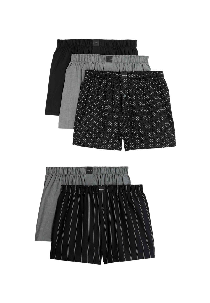 Cinco pares de calzoncillos de diferentes colores: negro sólido, gris sólido, negro con puntos, cuadro gris y negro con rayas blancas. Cinturas elásticas.