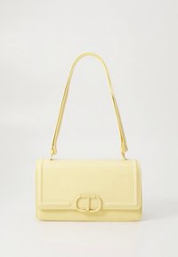 Yellow leather handbag with a rectangular shape, a smooth texture, and a front clasp featuring a circular hardware design.