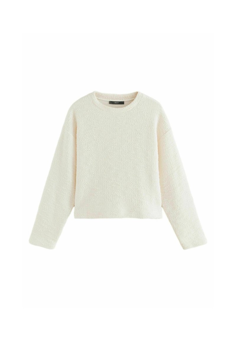 Crème kleurige pullover trui, cropped ontwerp met lange mouwen, gemaakt van gestructureerde stof. Heeft een ronde halslijn en een subtiel breipatroon.