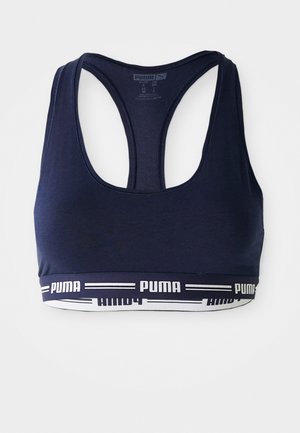 Navyblauwe sportbeha met een racerback-ontwerp, textuurstof en een witte gebrandmerkte elastische band aan de onderkant.