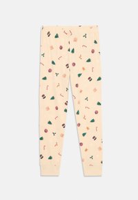 Pantalones de pijama beige con estampado navideño que presenta árboles, bastones de caramelo, tambores, acebo, regalos, renos, galletas de jengibre y copos de nieve.