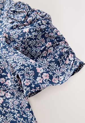 Blue floral fabric with white and pink flowers; gathered sleeve detail; lightweight material with a soft texture; feminine floral pattern.