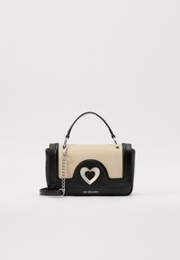 Black and beige handbag made of synthetic materials, featuring a heart design with silver hardware and chain strap. Brand name displayed on front.