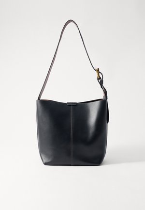 Black leather shoulder bag with a smooth texture, featuring a thin, long strap and a subtle stitched detail down the center.