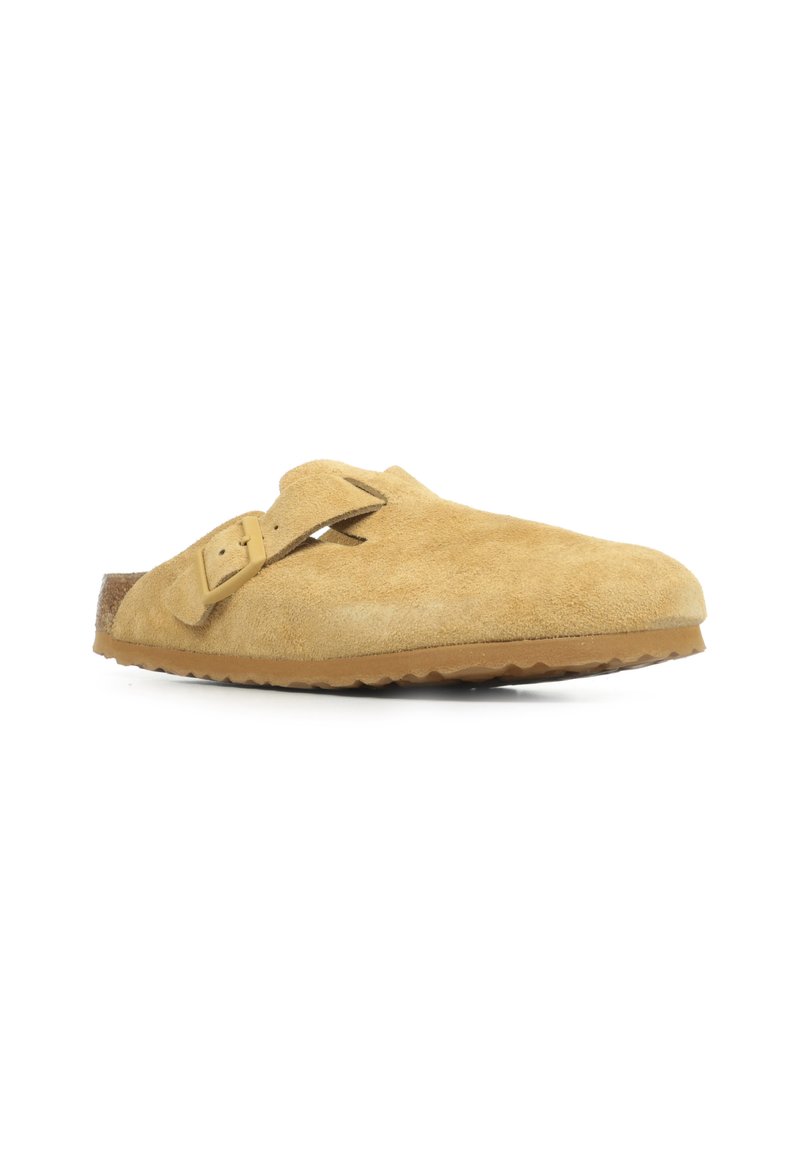 Scarpa slip-on in suede marrone con una singola fascia regolabile, punta rotonda e suola texture. Caratterizzata da una finitura morbida e liscia.