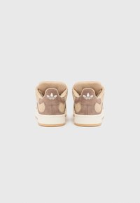 Brown suede high-top sneakers with beige accents, white logo detail on heel, and cream rubber sole. Smooth texture with cushioned collar.