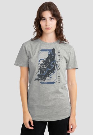 Woman wearing light gray t-shirt with dark blue and black stylized Dementor figure and vertical text "DEMENTOR" on front.