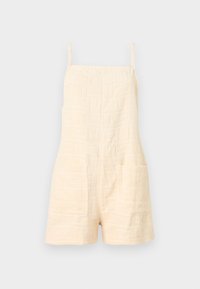 Ολόσωμο σορτς από κρεμ υφασμάτινη ύφανση με λεπτές τιράντες και δύο μπροστινές τσέπες, σχεδιασμένο για καθημερινή χρήση.