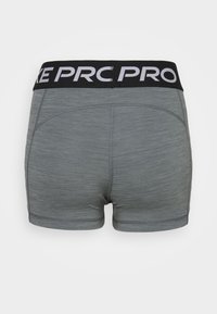 Grey athletic shorts featuring a black elastic waistband with white lettering. The fabric has a subtle texture and a fitted design.