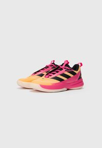 Sportssneakers med en gul og pink farveskema, sorte striber, en struktureret overdel og polstret sål.