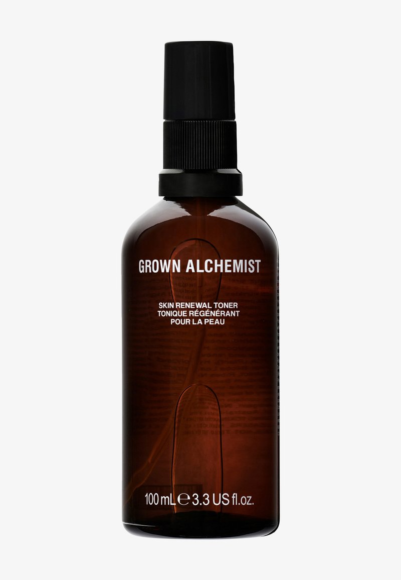 Bouteille en verre ambré avec un bouchon de pompe noir, étiquetée "GROWN ALCHEMIST" et "TONIQUE DE RÉNOVATION DE LA PEAU," contenant 100 mL de liquide.