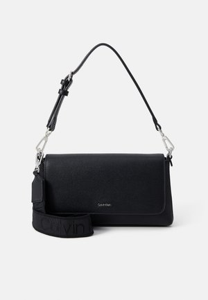 Black textured leather shoulder bag with flap closure, adjustable strap, and branded fabric detachable wide strap.