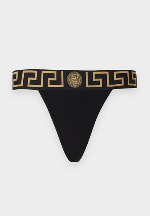 Juodos thong tipo apatinės kelnaitės su plačiu auksiniu raštuotu dirželiu, turinčiu liūto galvos emblema ir graikų raktų dizainą. Pagaminta iš medvilnės mišinio.