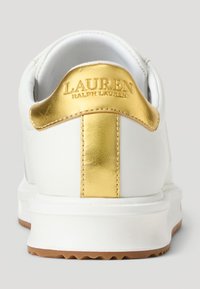 Bijela tenisica s glatkim kožnim gornjištem, s zlatnim akcentom na peti s utisnutim natpisom "LAUREN RALPH LAUREN". Gumeni potplat s dobrom prionjivošću.