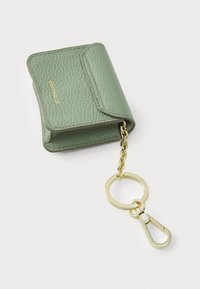 Mint green leather wallet with a textured finish, featuring a gold chain and keyring attachment. Folded design with subtle stitching details.