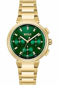 Orologio in metallo dorato con quadrante verde, tre sotto-quadranti, indicatori delle ore tempestati di gemme e bracciale a maglie. Presenta il marchio BOSS.