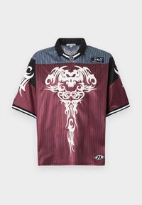 Κοντομάνικο πουκάμισο από απαλό ύφασμα, με μπορντό σώμα με ριγέ σχέδιο, μαύρες λεπτομέρειες και λευκή φυλετική εκτύπωση στο μπροστινό μέρος.