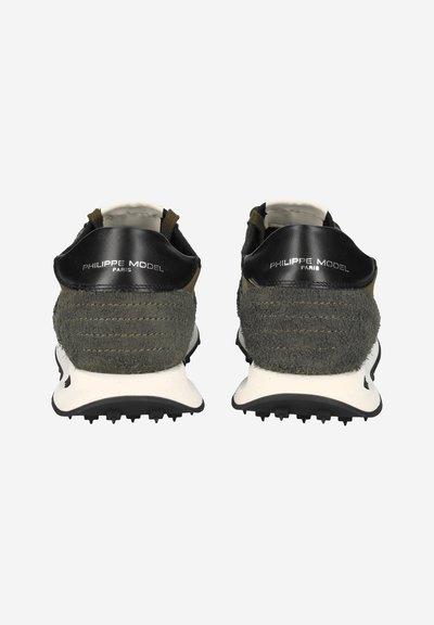 Green and black sneakers with a textured suede upper, leather accents, and a white midsole. Distinct logo detailing on the heel.