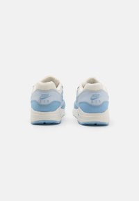 Nike Air tenisice u svijetloplavoj i bijeloj boji, izrađene od kože i mrežastog materijala, zaobljenog oblika i s podstavljenom podrškom za gležanj.