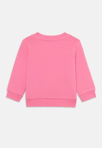 Rosa sweatshirt med långa ärmar, ribbade muddarna och midjan. Slät textur, rund halsringning, inga synliga mönster eller loggor.