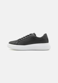 Black leather sneakers featuring a textured pattern, white rubber sole, rounded toe, and six eyelet lace-up closure.