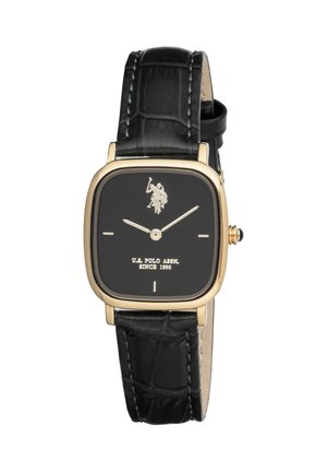 Cadran de montre carré noir avec cadre doré, index horaires minimalistes, logo U.S. Polo Assn. et bracelet en cuir noir avec détails de couture.