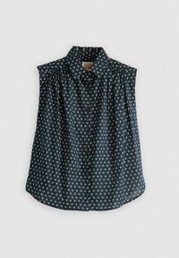 Camicetta blu navy con motivo floreale bianco, chiusura con bottoni e maniche corte. Presenta spalle plissettate e orlo arrotondato.