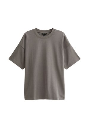 Camiseta de algodón gris con cuello redondo, mangas cortas caídas y corte relajado. Textura suave y diseño minimalista.