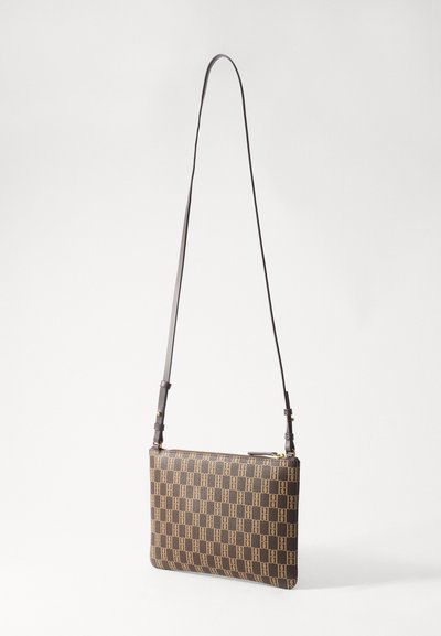 Brown patterned leather handbag with a long, adjustable strap and a zip closure; features a geometric design in contrasting tones.
