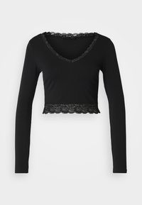 Black long-sleeve crop top with a V-neck, featuring a scalloped lace trim around the neckline and at the hem. Soft, stretchy fabric.